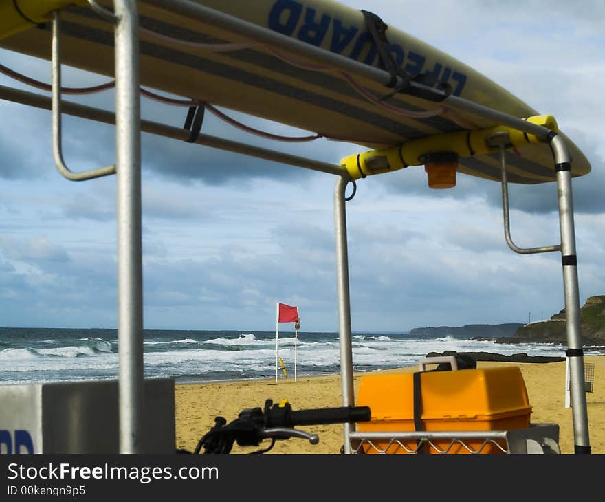 A lifeguard vehicle with resuce board overlooking a wild beach. A lifeguard vehicle with resuce board overlooking a wild beach.