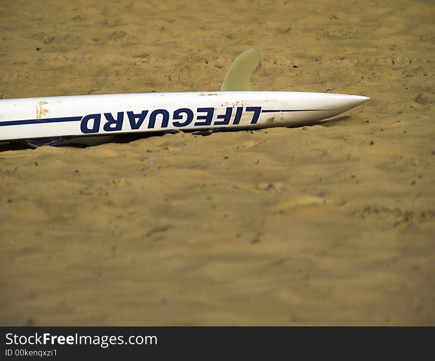 A lifeguard rescue board on the sand