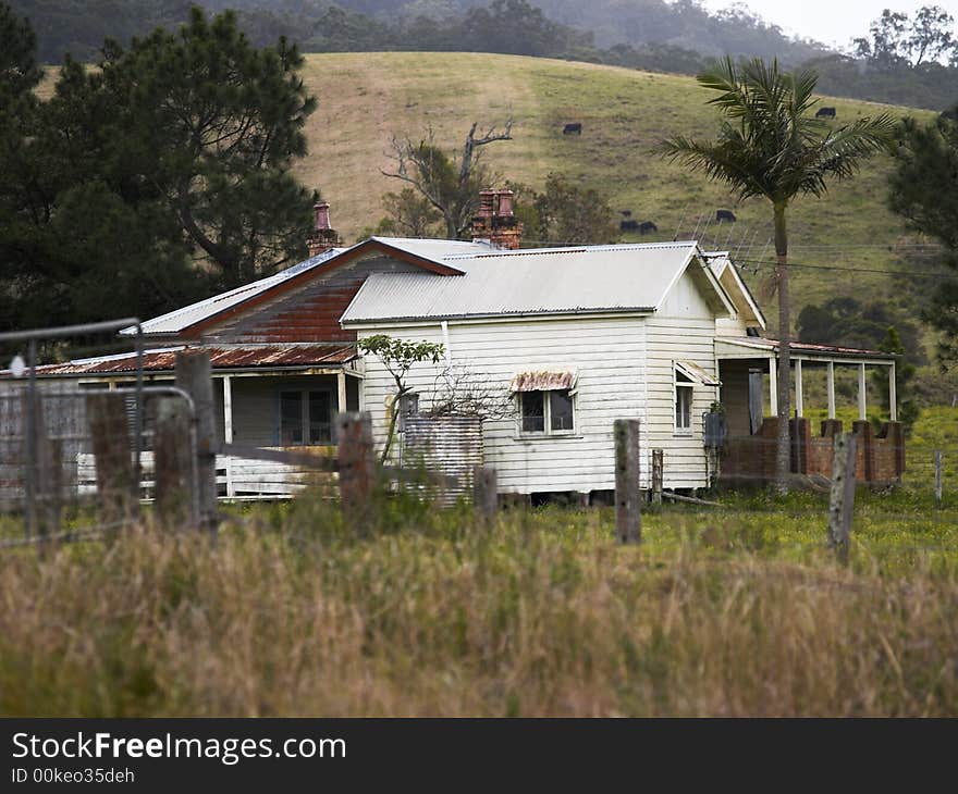 A rural scene of an old, abandonded farmhouse. A rural scene of an old, abandonded farmhouse