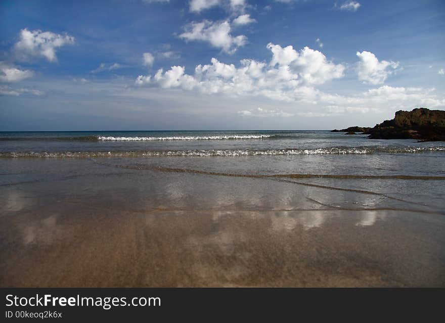 Sandy Beach And Cloudy Sky