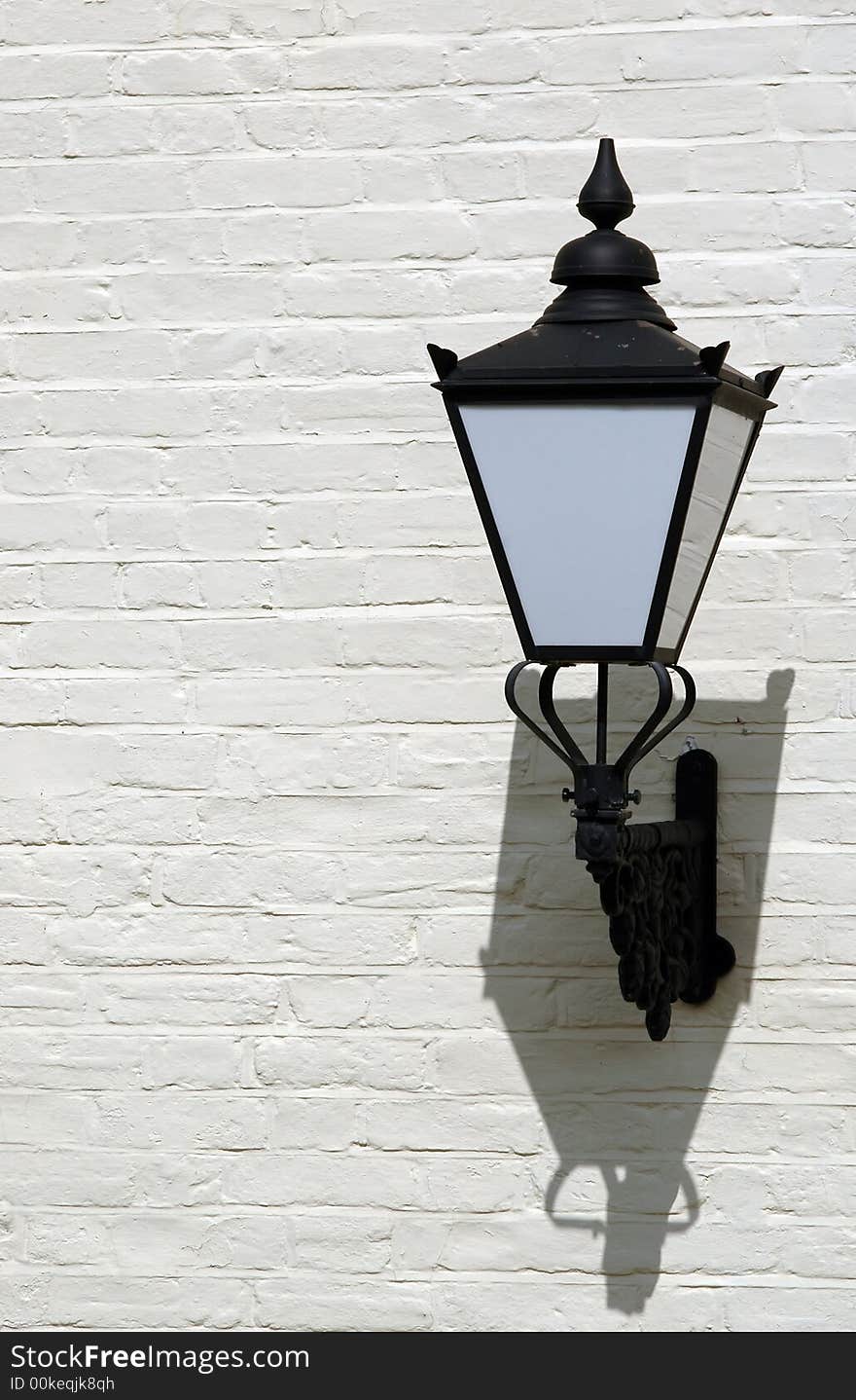 Decorative street lamp of painted brick wall