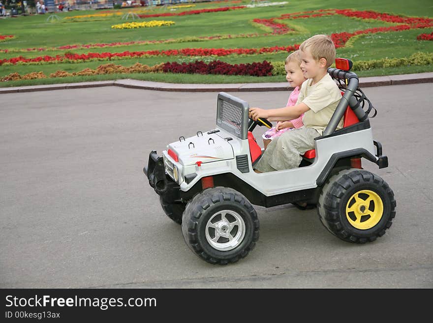 Boy and girl in toy car