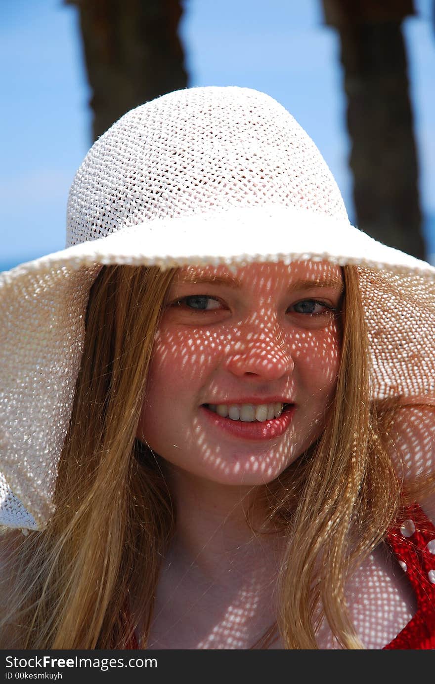 Smile girl on a white hat