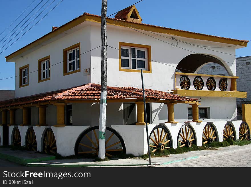 A white building with wheels used as a decoration. A white building with wheels used as a decoration