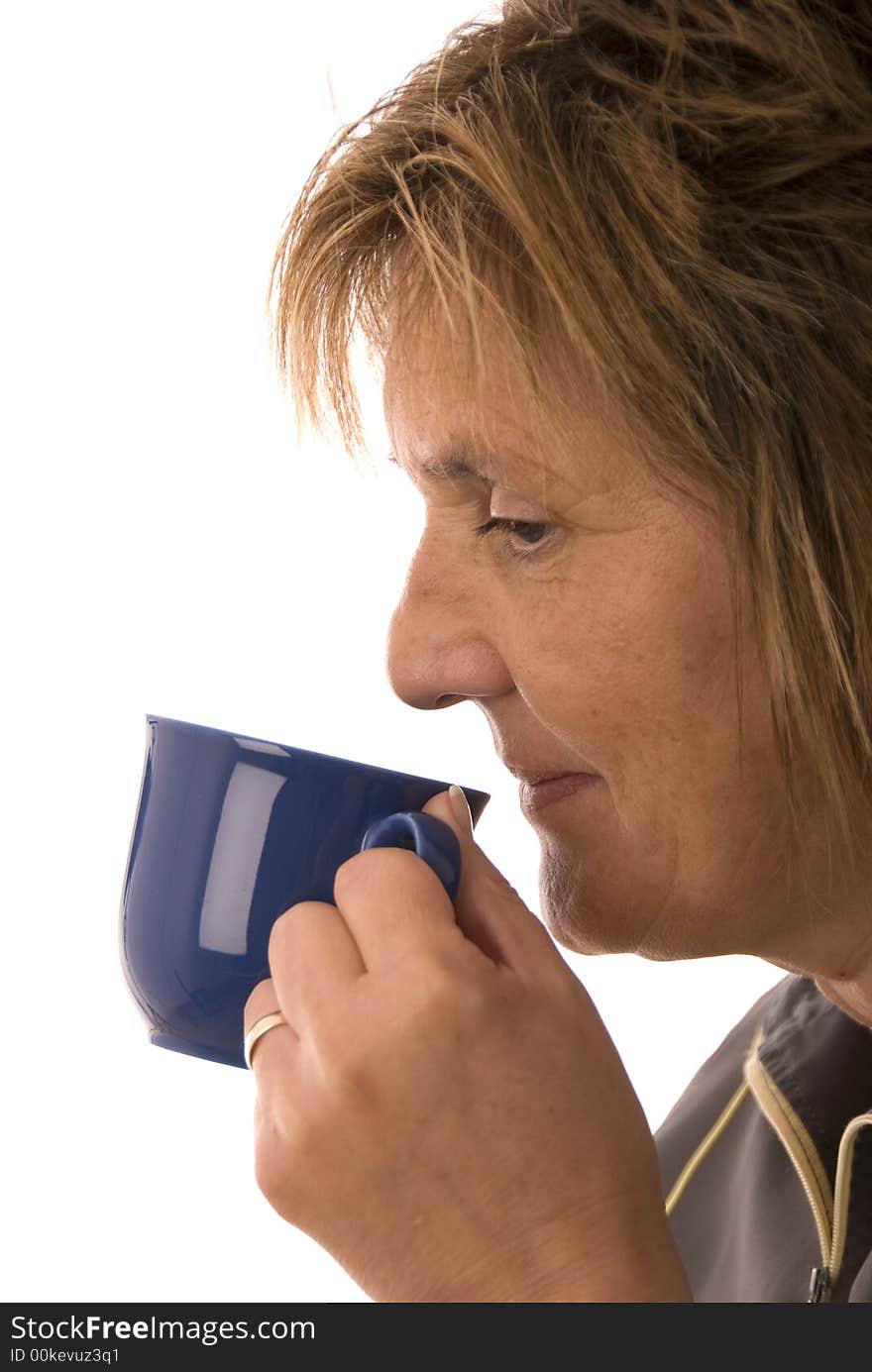 Smiling woman drinking from cup. Smiling woman drinking from cup