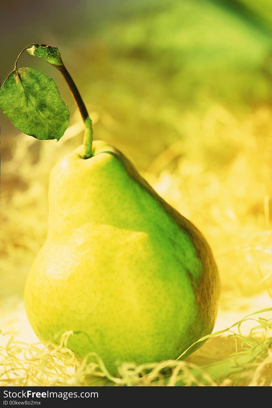 Green pear on a yellow background