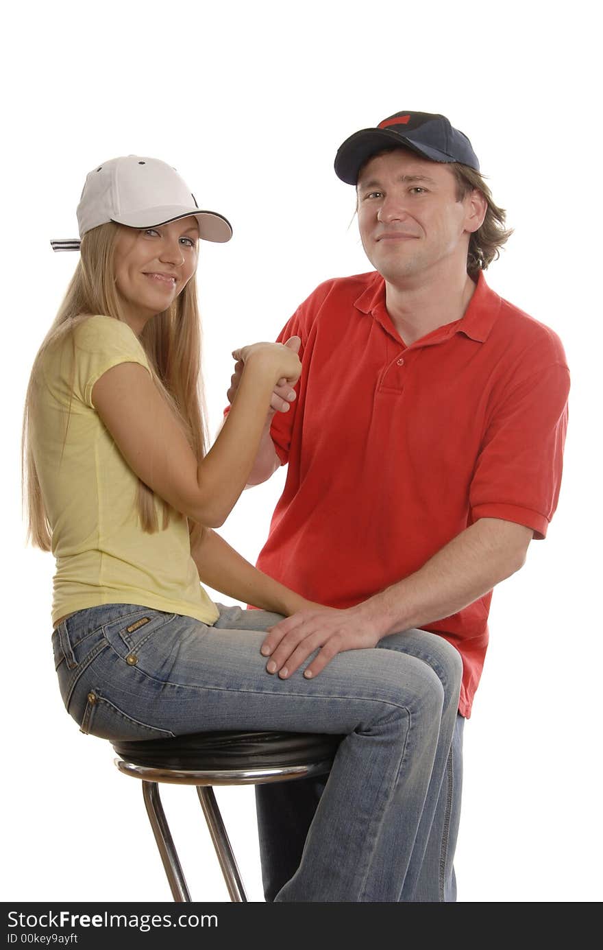 A man in black cap is holding girl's hand who is wearing sport clothes. A man in black cap is holding girl's hand who is wearing sport clothes