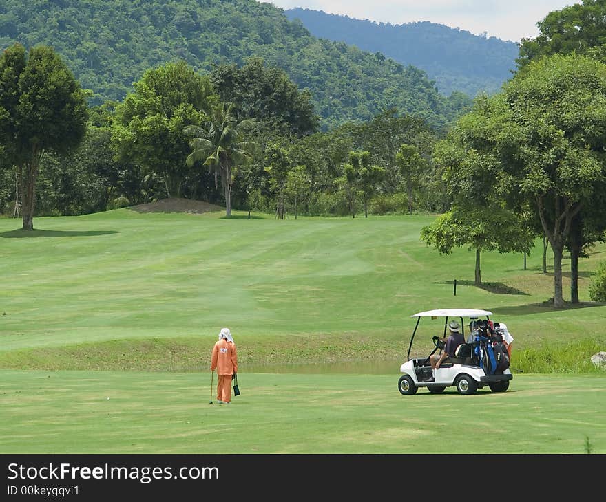 Caddie And Golf Cart On The Fa