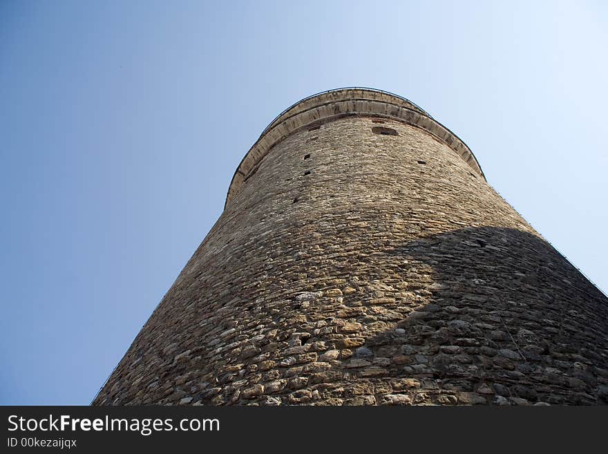 The bottom view on historical a tower from stones. The bottom view on historical a tower from stones