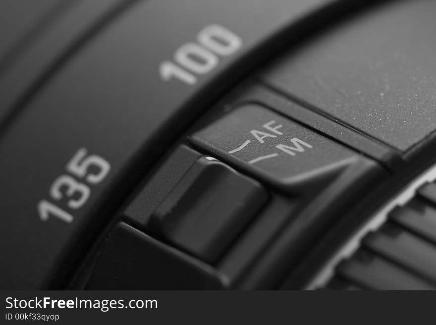 Closeup of a lens, manual and autofocus button. Closeup of a lens, manual and autofocus button