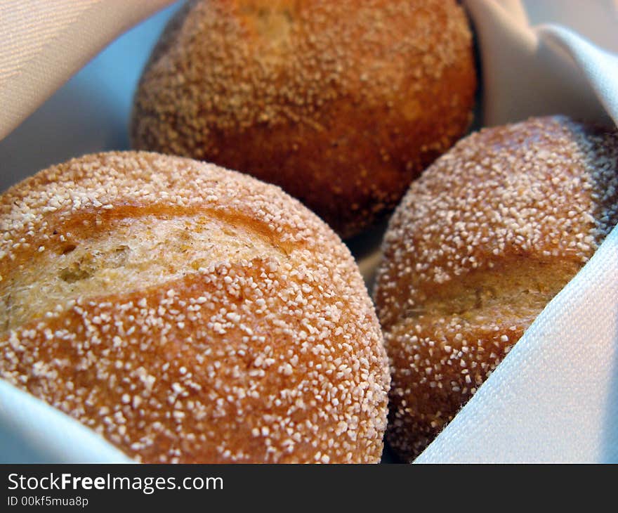 Three warm bread rolls in a basket