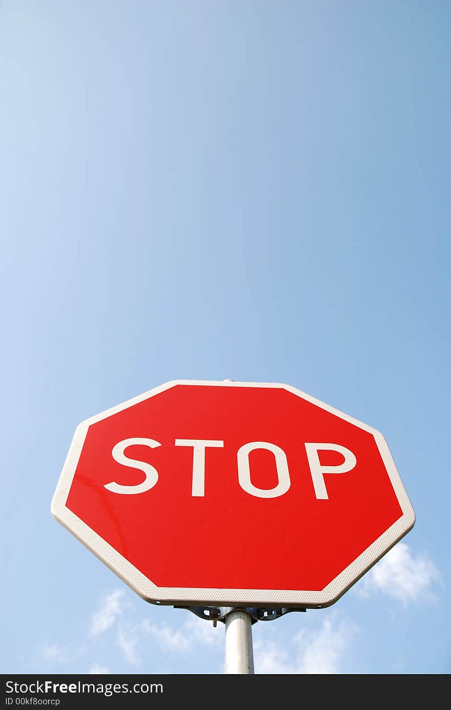 Stop sign on the blue sky