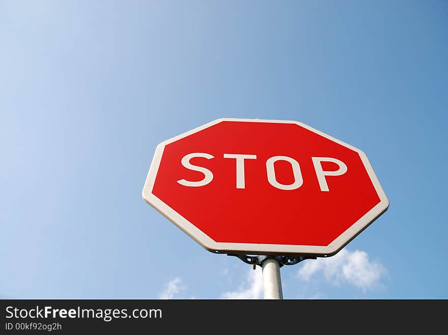 Stop sign on the blue sky