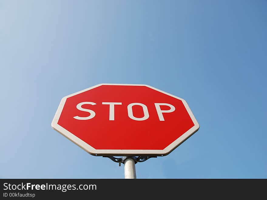 Stop sign on the blue sky