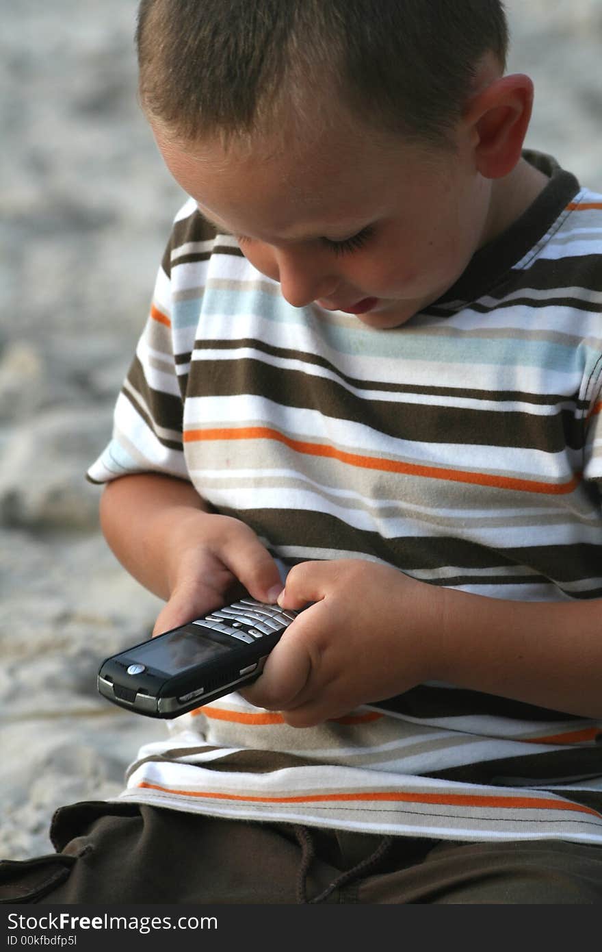 Little boy using a mobile phone. Little boy using a mobile phone