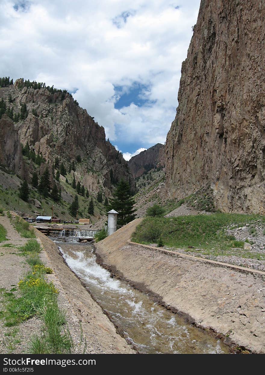 The water flows down a man made chute in the mining town of Creede, Colorado. The water flows down a man made chute in the mining town of Creede, Colorado