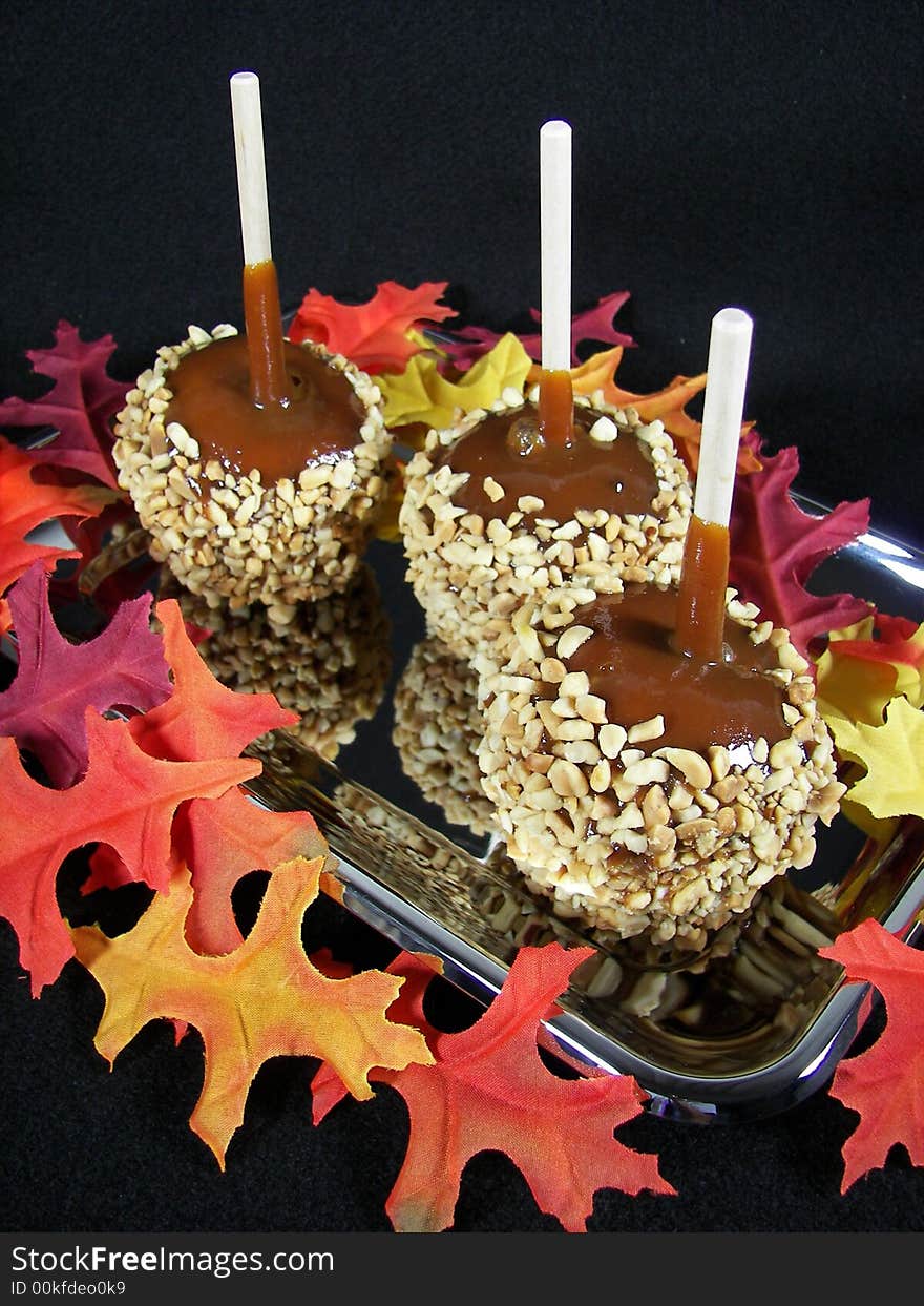 Caramel apples with colorful leaves. Caramel apples with colorful leaves.