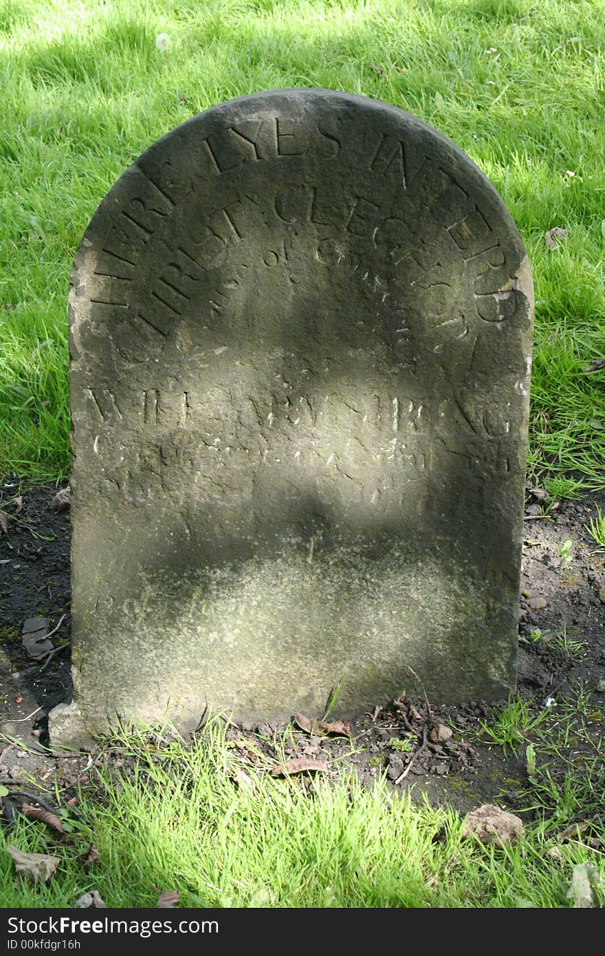 Antique headstone with faded inscription