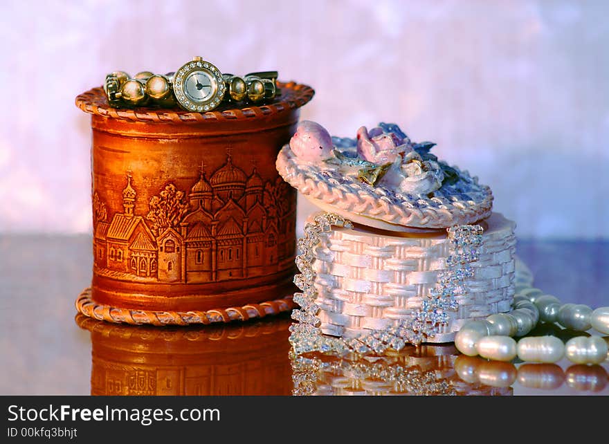 Necklace and gold watch and pearl in small boxs