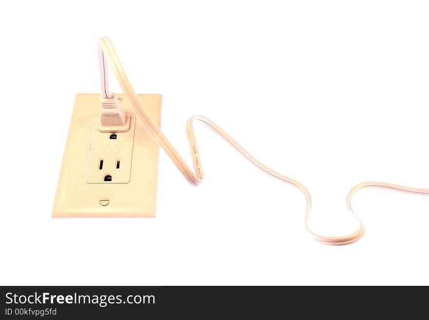 Extension cord plugged into an outlet isolated on a white background