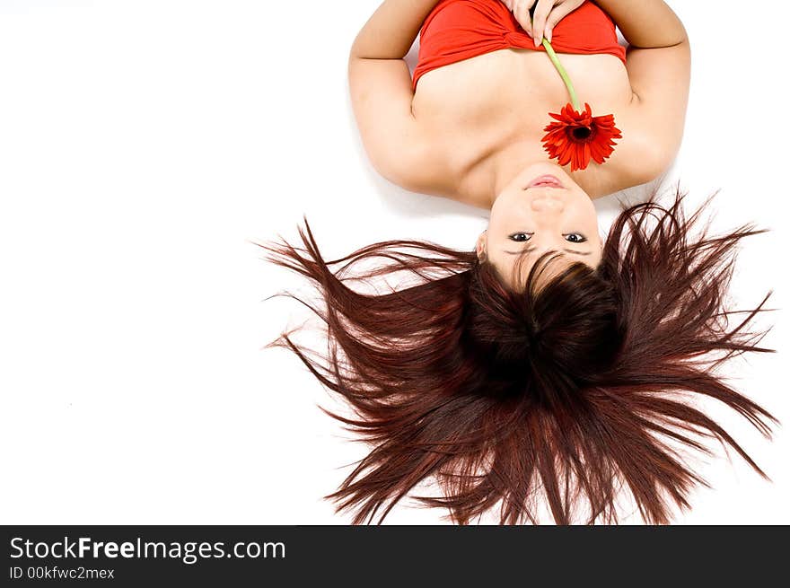 An attrative young Asian woman in white top holding a red flower on white background. An attrative young Asian woman in white top holding a red flower on white background