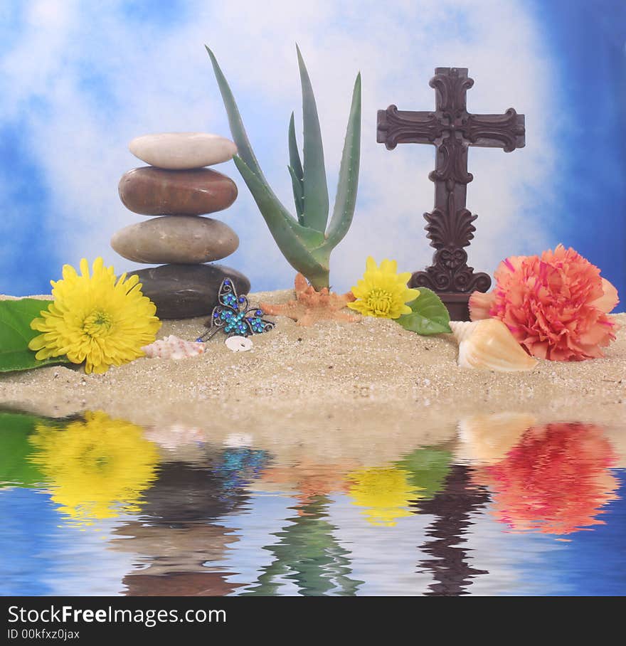 Cross and Flowers on Sand With Aloe Vera Plant