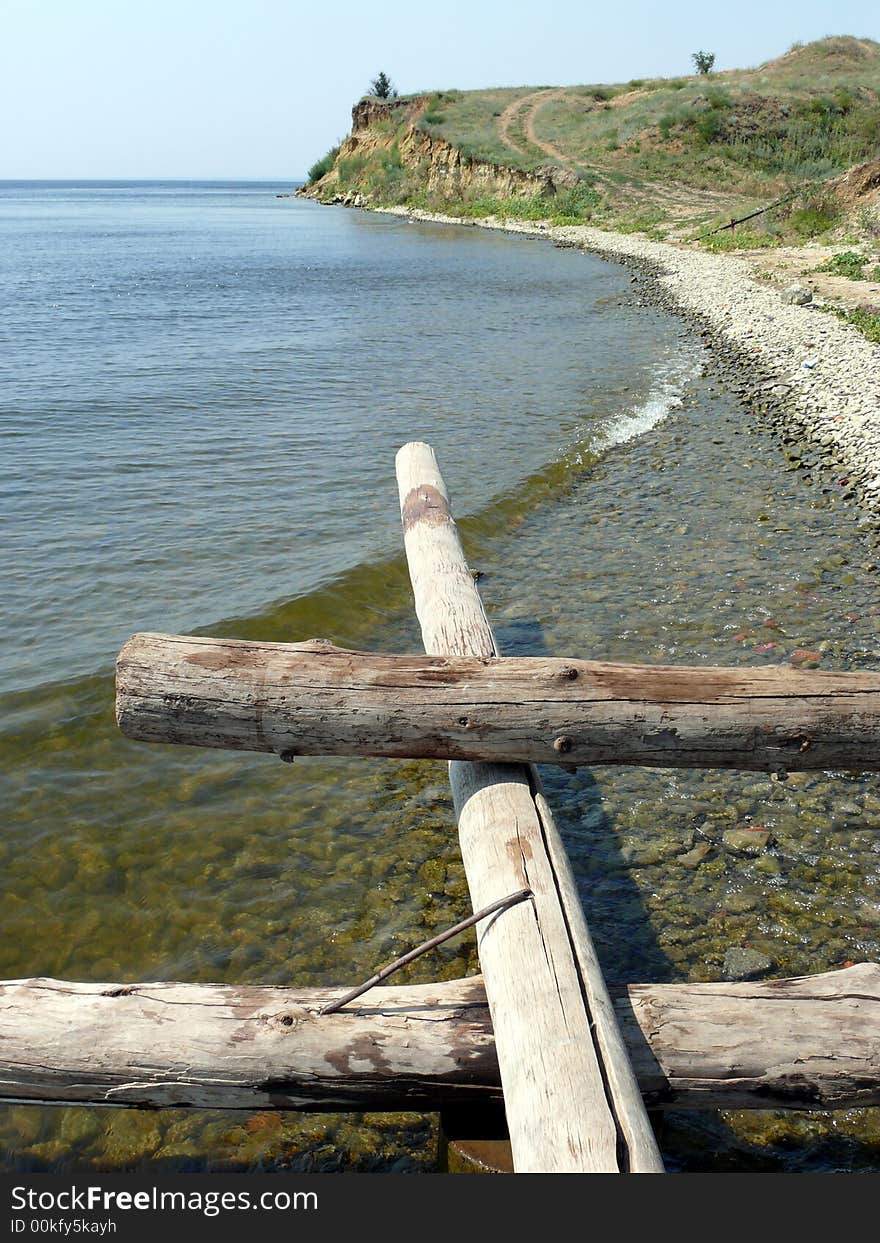 Logs And Stones On Seacoast