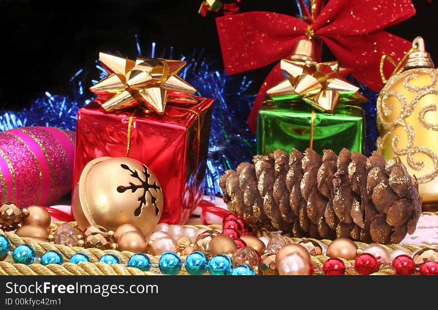 Christmas Gifts With Beads and Pine Cone on Black Background. Christmas Gifts With Beads and Pine Cone on Black Background