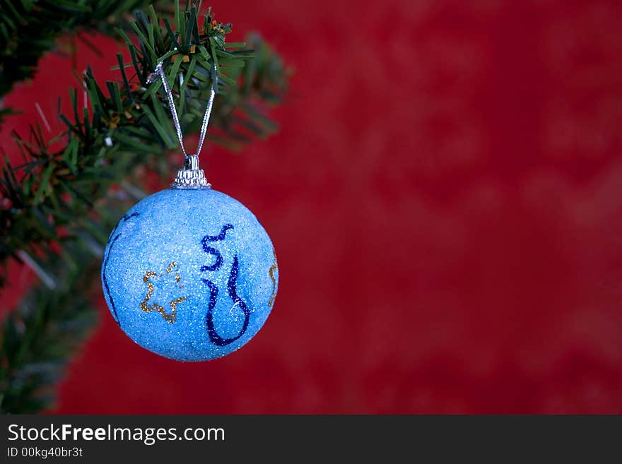 Blue christmas ball on red background