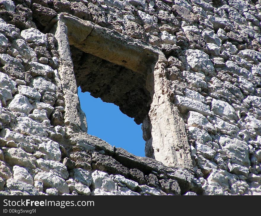 Stone window and nice blue sky on old castle