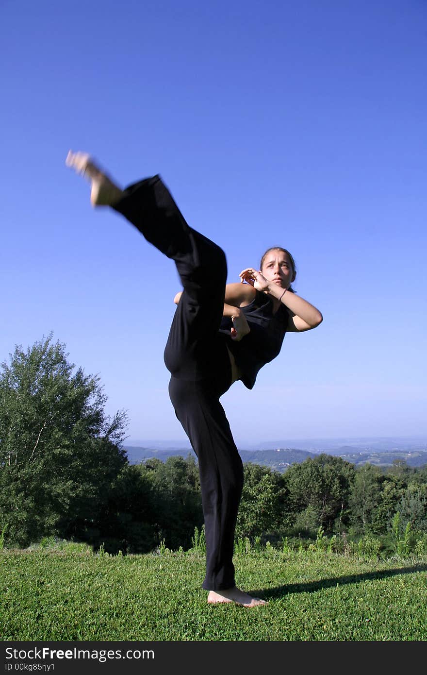 Attractive young woman practising self defense