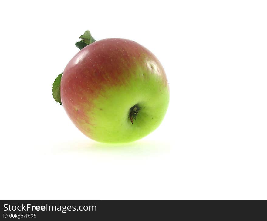 The isolated red apple with green foliage on a white background. The isolated red apple with green foliage on a white background.