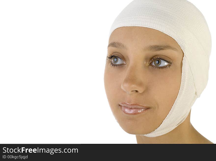 Young, beautiful woman with bandage on head. Smiling and looking at something. Side view, white background