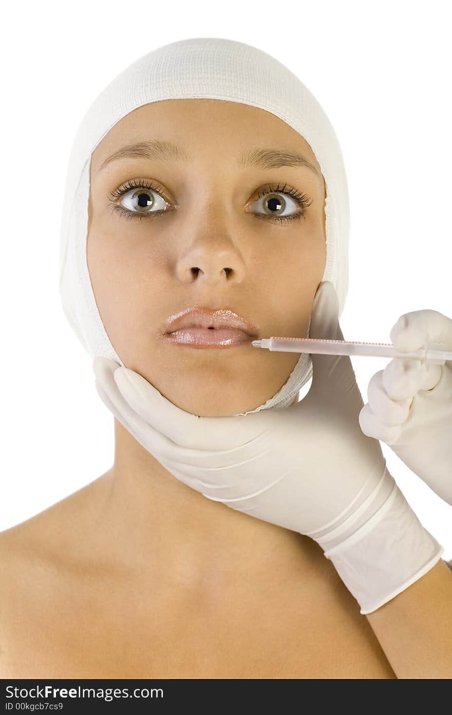 Young, beautiful woman with bandage on head. Somebody is injecting something in her's lips. Front view, white background. Young, beautiful woman with bandage on head. Somebody is injecting something in her's lips. Front view, white background