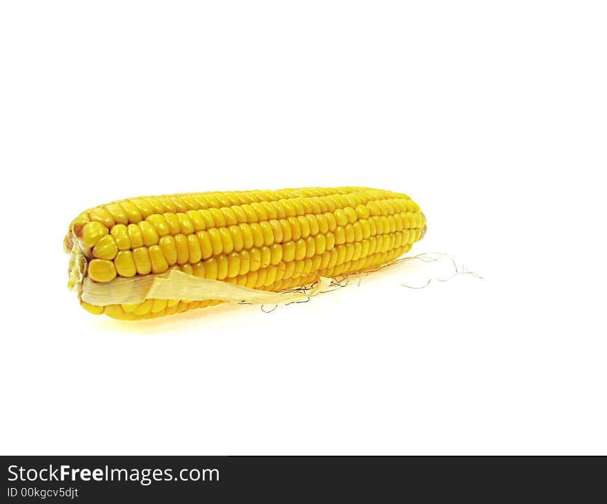 An ear of sweet corn isolated on a white background. An ear of sweet corn isolated on a white background