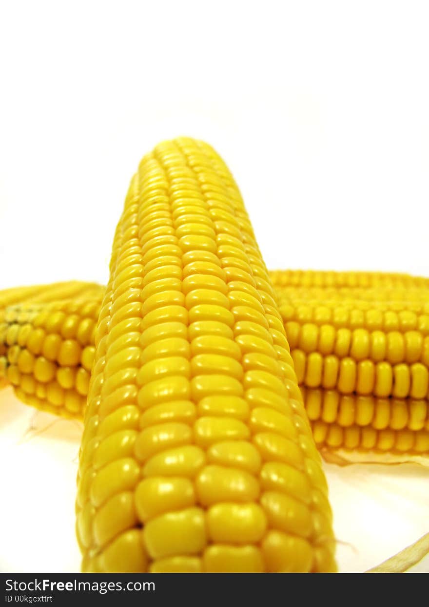 An ear of sweet corn isolated on a white background. An ear of sweet corn isolated on a white background