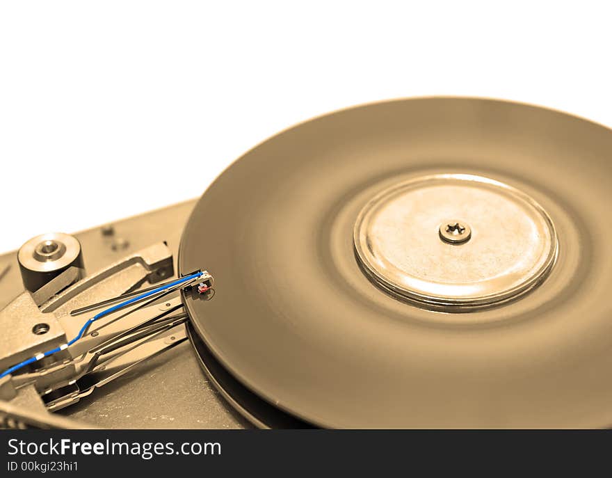 Close-up view of head and disk of HDD in sepia. Close-up view of head and disk of HDD in sepia