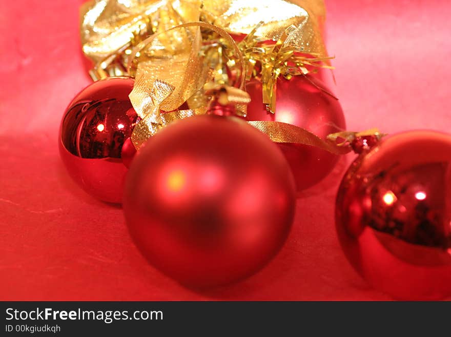 Three red christmas baubles and a golden bow ,christmas decoration. Three red christmas baubles and a golden bow ,christmas decoration