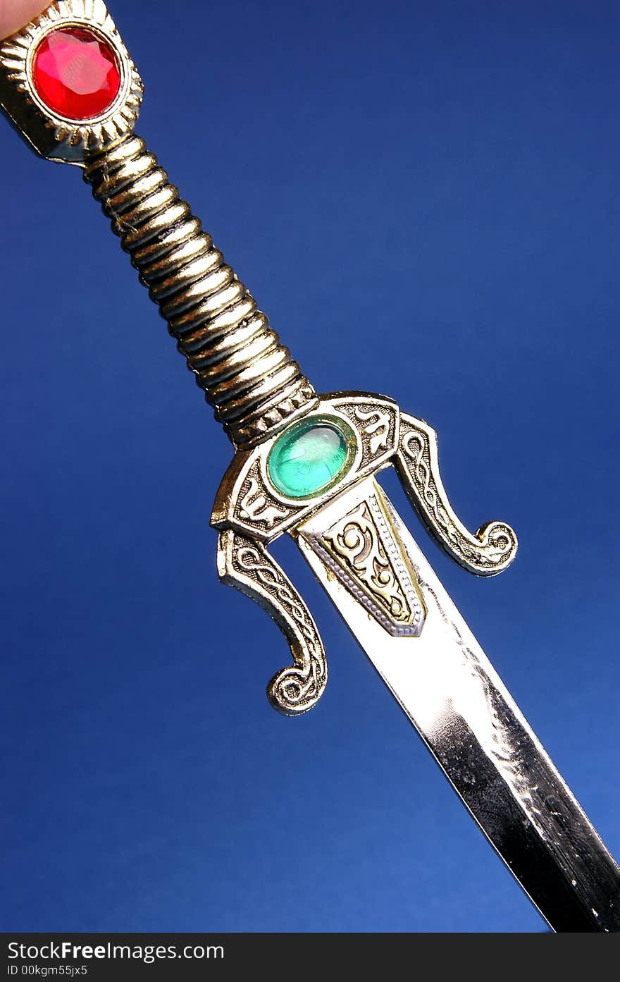 Photo of ornamental knife on the blue background