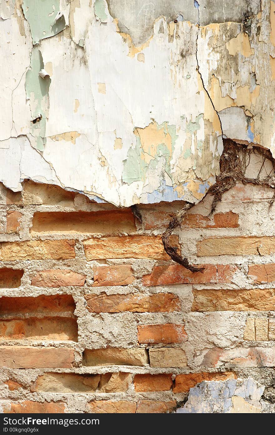 Old cracked wall with brick exposed and peeled paint