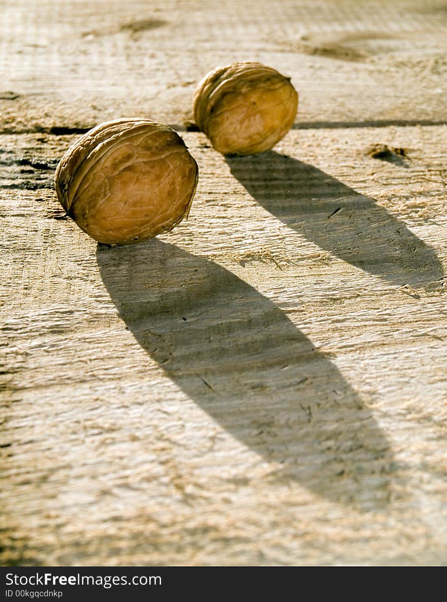 Two hard walnutes on a desk