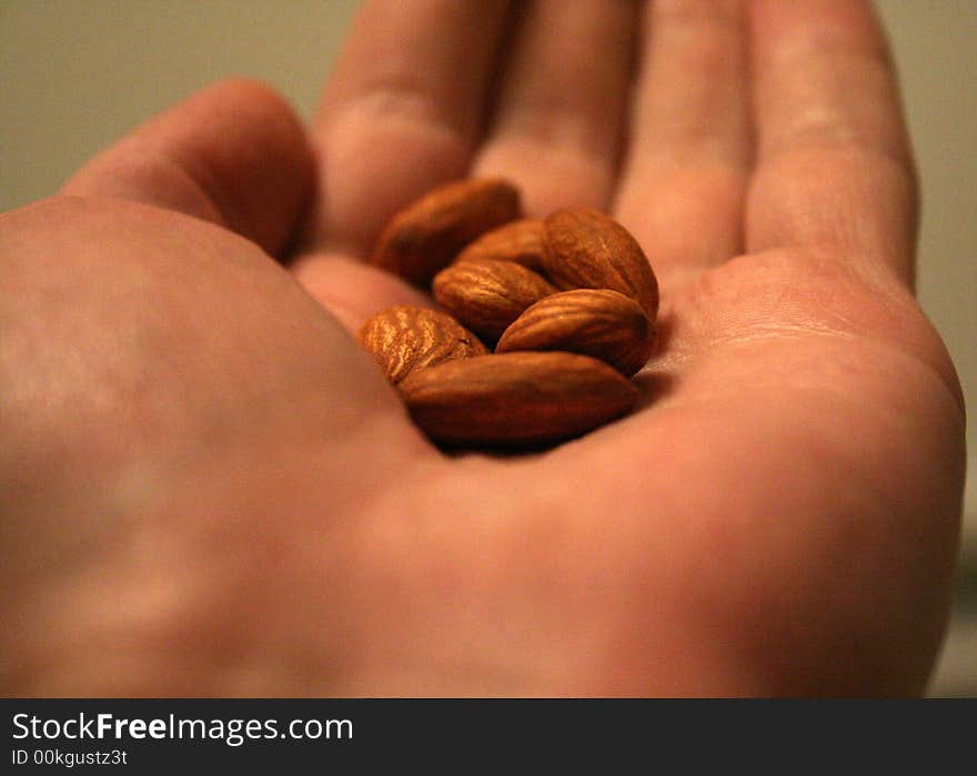 A handful of almond nuts on a palm