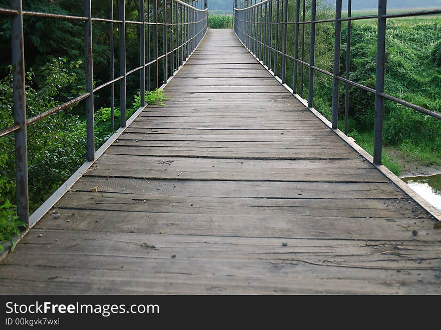 Old wooden bridge on the river