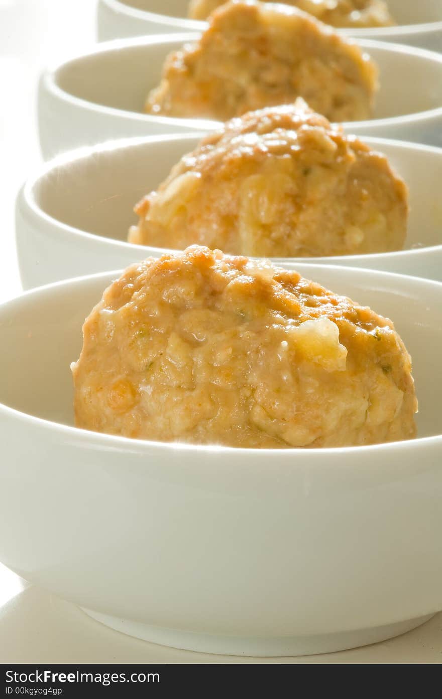 Beef and pork meat ball served on white bowls with focus on first ball