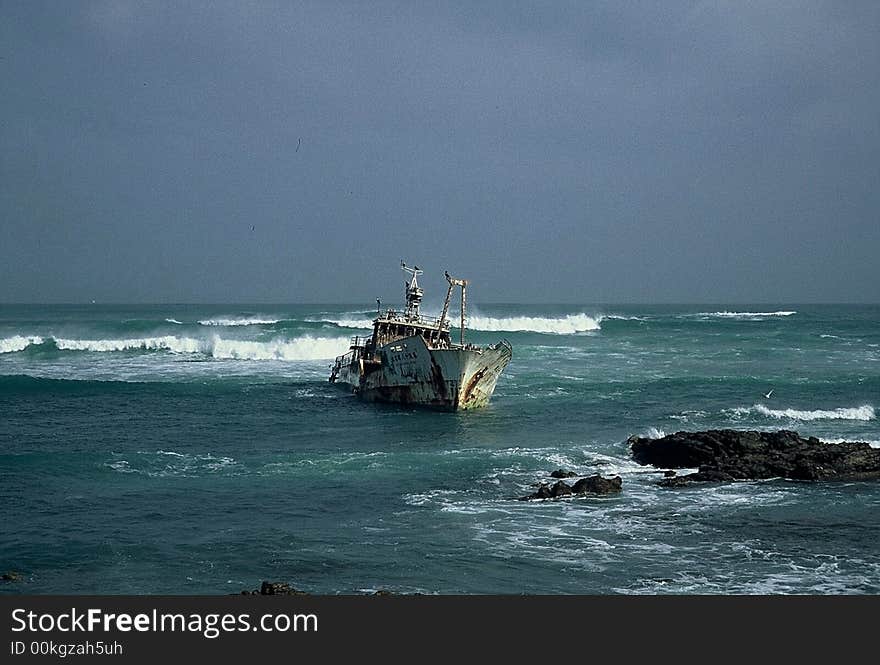 Old fishing trawler sitting on the rocks. Old fishing trawler sitting on the rocks