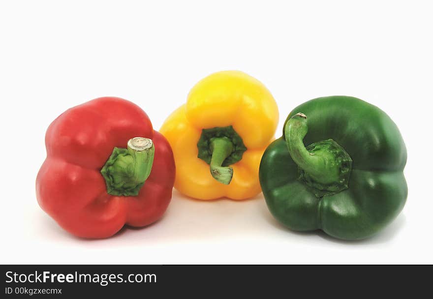 Red, Yellow and green peppers isolated against a white background