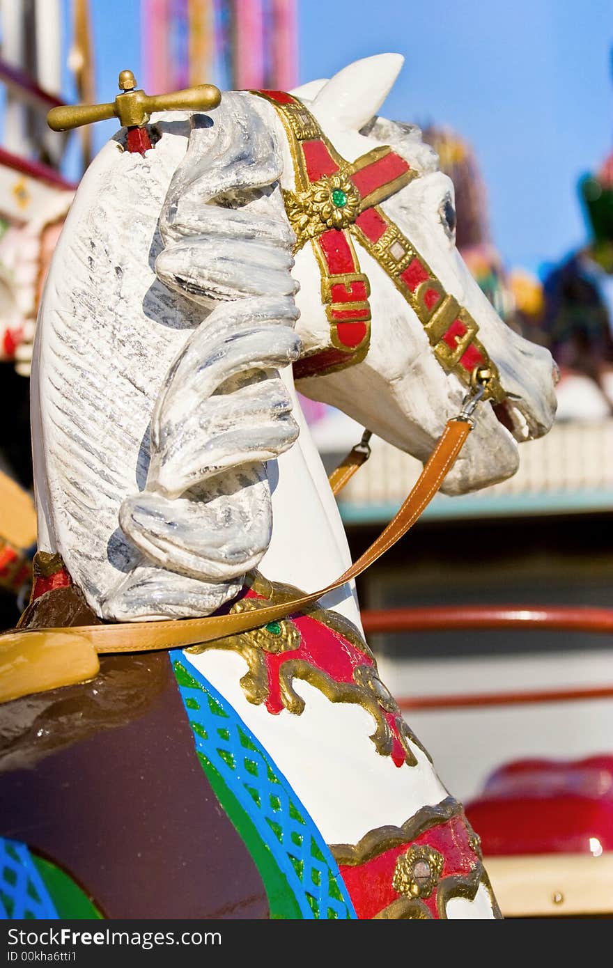 An old wooden carousel horse in summer. An old wooden carousel horse in summer