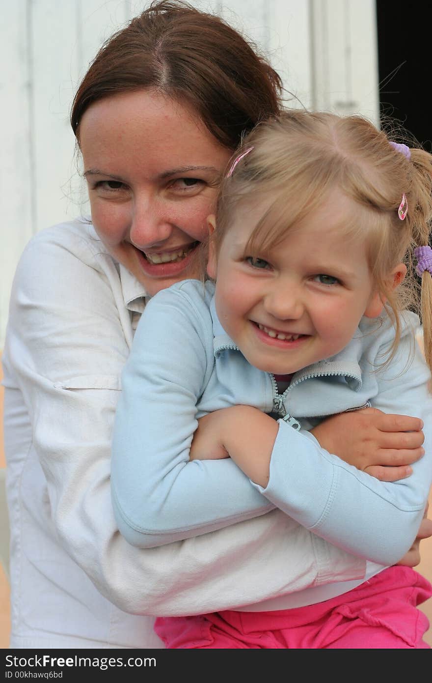 Mother and daughter hugging together.