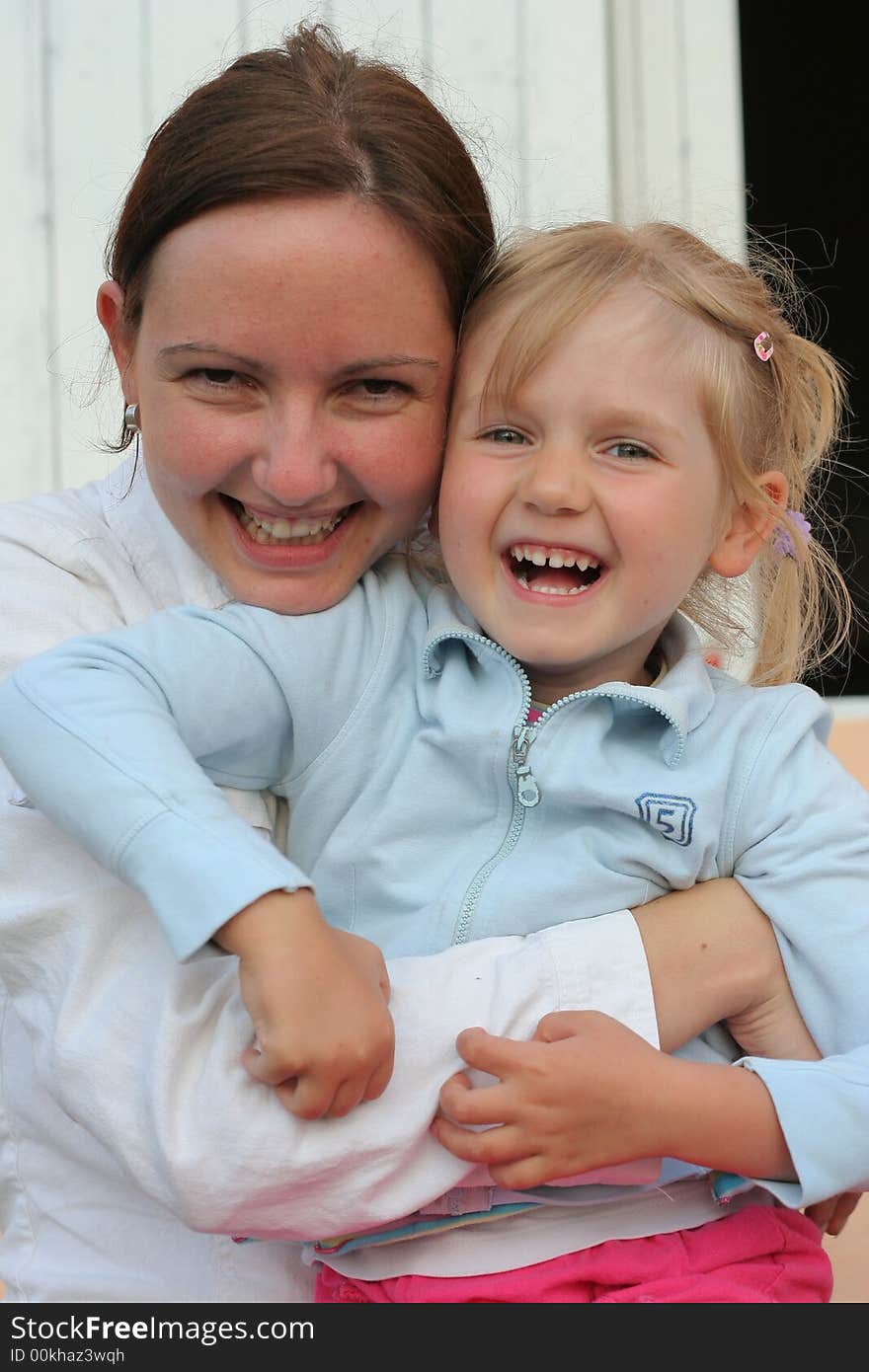 Mother and daughter hugging together.