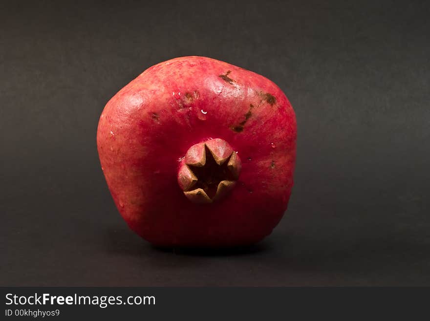 Fresh pomegranate on black background